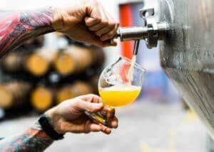 home brew being poured from fermenter