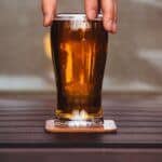 Man holding Home Brewed brown ale