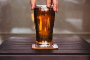 Man holding Home Brewed brown ale