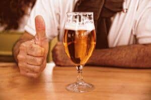 Man giving a thumbs up to his home brew