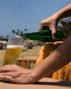 Man pouring home brewed beer into a beer glass