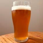 Home brew beer in beer glass on coffee table