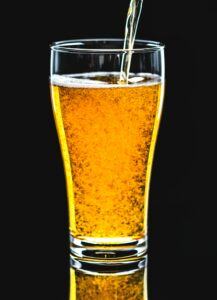 Clear Home Brewed Beer Being Poured into a beer glass