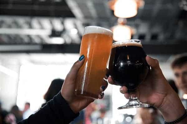 two people doing cheers with homemade beer